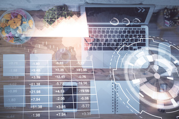 Stock market graph and top view computer on the table background. Multi exposure. Concept of financial education.