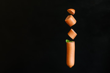 sausage cut into pieces with sauce black back serving size portion meat product natural raw top view place copy space for text