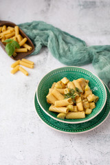 Vegan Rigatoni Dish in a Green Bowl on a White Background