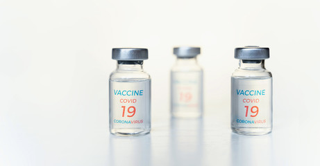Closeup transparent vials with new vaccine for covid-19 coronavirus, flu, infectious diseases. Injection after clinical trials for vaccination of human, child, adult, senior. Medicine, drug concept