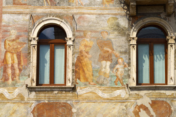 Fototapeta na wymiar Trento, Italy: painted facade of historic buildings in the cathedral square