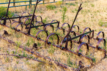 Spring tooth harrow stored in a farmer's field near Denver awaiting planting season next spring