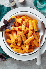 pasta with baked peppers and cashews sauce. vegan full-fledged healthy lunch or dinner with purple basil