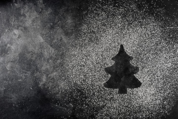 fir tree made from flour on a dark table