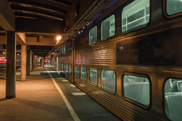 Commuter train at rest against an empty platform in city