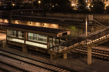 Fototapeta na wymiar Empty train platform with well lit shelter on lonely night