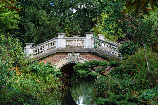 Stone arch bridge over a stream in the Parc Monceau - Paris, France. It is modeled after the Rialto bridge in Venice.