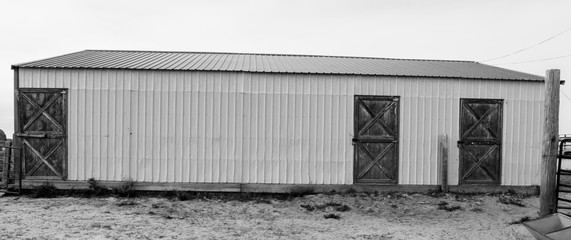 Fototapeta premium Rustic metal barn with wooden barn doors on a working ranch near Denver