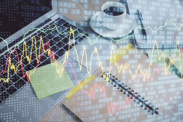 Multi exposure of forex graph drawing and desktop with coffee and items on table background. Concept of financial market trading