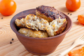 Juicy delicious fish cutlets on wooden background