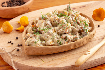 Chanterelle mushrooms fried in sour cream. Rustic style