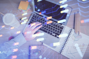 Multi exposure of man's hands typing over computer keyboard and data theme hologram drawing. Top view. Technology concept.