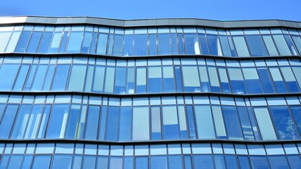 Obraz premium Glass curtain wall of modern office building. Modern office building on a clear sky background.