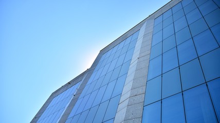 Fototapeta na wymiar Glass curtain wall of modern office building. Modern office building on a clear sky background.