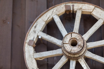 A wooden wheel from an old cart nailed to the wall.