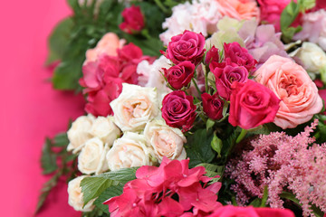 a fragment of the wedding table decor made of fresh flowers with a crimson accent