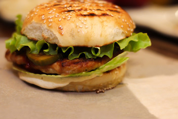 Burgers with lettuce, cutlet and tomatoes. Burgers in the restaurant. Burgers close up. Fast food, wrong food. Fat. Obesity