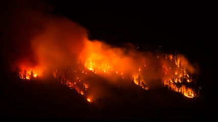 Wildfire burns on side of a mountain