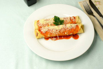 beef pancake with red sauce and parmesan cheese on a plate