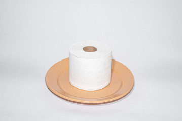 Toilet paper on the brown plate on white background