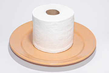 Toilet paper on the brown plate on white background