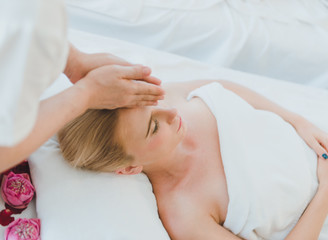 Beautiful woman lying on the bed for a spa asia massage at luxury spa and relaxation.