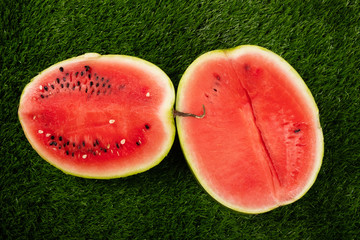 berry, pumpkin, ripe juicy red watermelon lies on green grass, picnic, half watermelon