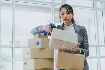 A beautiful businesswoman working at home is checking the amount of products that will be delivered...
