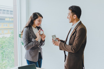 Young Asian businessmen are discussing business deals about building houses for customers.