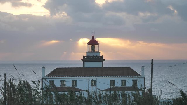 Beautiful Sunset With Sunrays Through Clouds At Light House, Azores