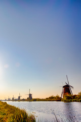 European Travel Ideas. Traditional Romantic Dutch Windmills in Kinderdijk Village in the Netherlands Before The Sunset.