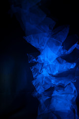 Dropping tissue papers flashed with blue light