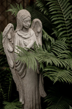 statue of angel with a cross