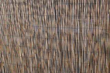 wooden fence the textures of the background of the reed fence is yellow brown bamboo