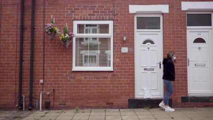 Girl safely dropping off a care package to grandparent's house | Wide shot - Powered by Adobe