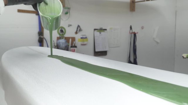 speed ramp slow motion paint pouring onto new surfboard
