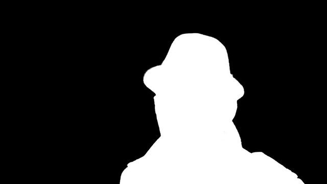 Young man puts on hat and walks away, white silhouette on black background.
