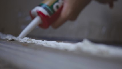 Silicone Sealant Application With A Caulking Gun - close up