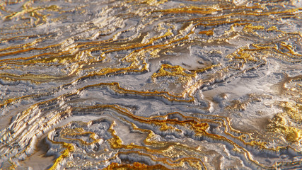 abstract wavy surface, grungy metal texture background in gold and silver