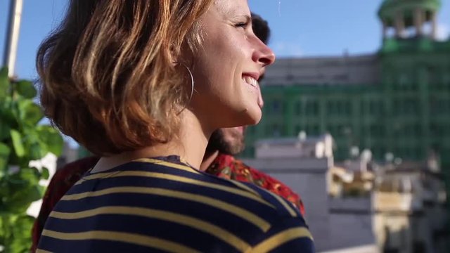 Couple on rooftop, optimistic and happy, in love, looking at view