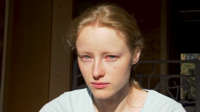 Close up portrait of crying woman. Females eyes all red after paintful night. Penetrating gaze. Emotions, feelings.