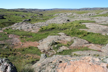 Natural texture. View of the rocky hill, green meadow and valley. 