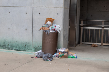 Cincinnati, OH / USA - April 23, 2019: Overflowing trash can on the street in Cincinnati. Garbage...