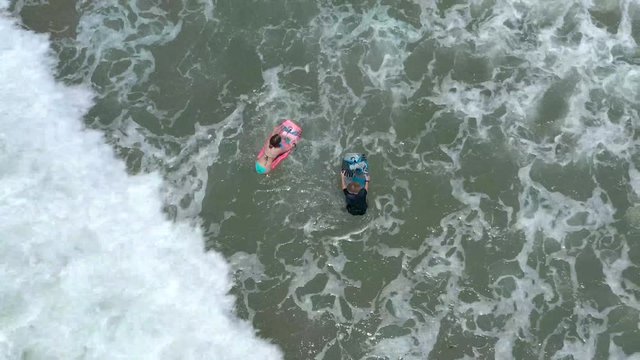 Kids body surfing at Ventura, California beach.