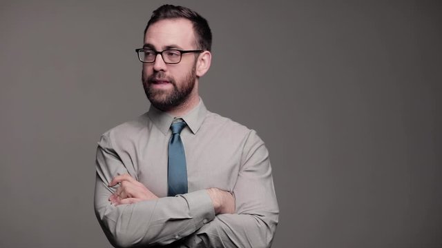 Professional man awkwardly doesn't know what do with his hands, medium shot