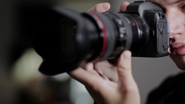 Photographer Taking Shots With His DIgital Single Lens Reflex Camera In The Studio - extreme close up