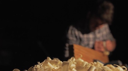 Carpenter hand planing pine timber shavings ejecting slow motion
