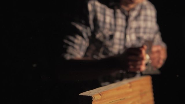Wood shavings ejecting from carpenters hand planer, Medium shot