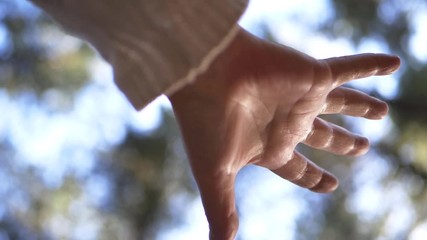 Single hand reaching out against bokeh background medium shot