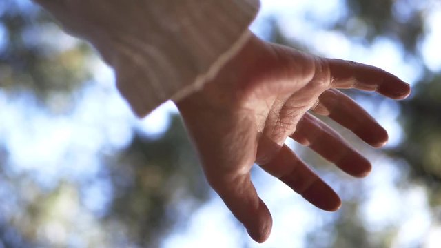 Single hand  reaching out against bokeh lights background medium shot